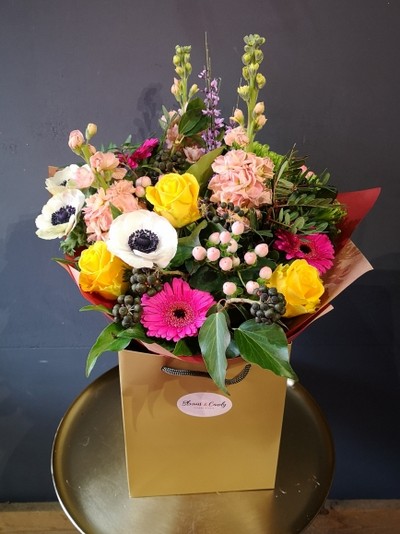 mixed spring flowers bouquet to include Anemones, scented stock, genista, berries, daisy and roses handmade by local florist in Croydon, Surrey, UK