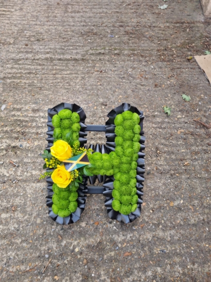 Funeral letters based in green spray chrysanthemum called 'button'. Perfect for Jamaican theme or Irish theme. Made by florist in Croydon