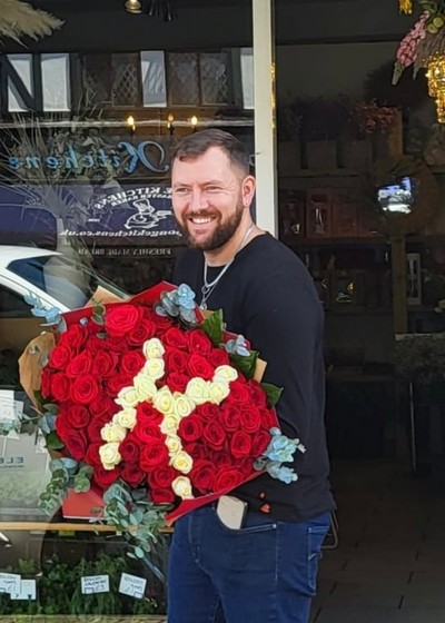 Big bouquet of red roses with white initial letter inside made by florist delivering to Croydon, Surrey