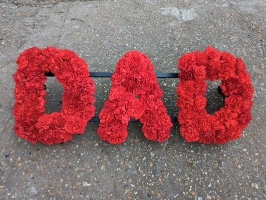 Funeral letter based only with carnations. Made by florist in Croydon