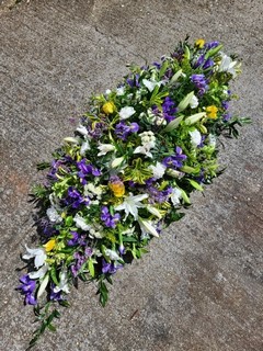 Lily and Iris coffin spray made by florist delivering to Croydon, Surrey