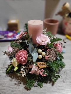 10 inch posy with pink pillar candle and pink fresh flowers and silver decorations. All made on winter greenery. Beautiful table decoration. For guaranteed Christmas delivery in Croydon, Surrey, UK