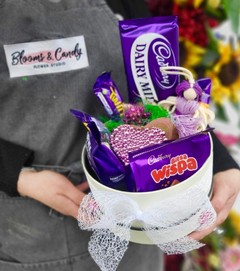 Hat box with Cadbury products with indoor planter in ceramic pot made by florist in Croydon 