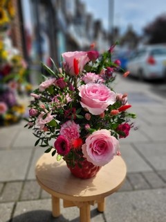 Raspberry ceramic pot arrangement made with fresh flowers by florist in Croydon, Surrey 