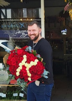 Big bouquet of red roses with white initial letter inside made by florist delivering to Croydon, Surrey