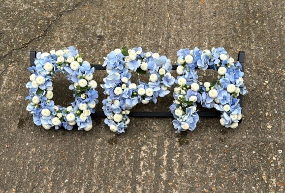 Funeral letters made of white button chrysanthemums and light blue hydrangeas. Designed by Croydon Blooms Florist